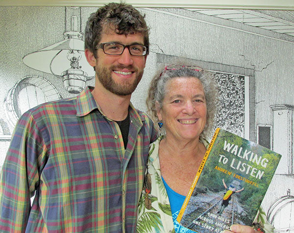 Man standing next to women holding a "Walking to Listen" book