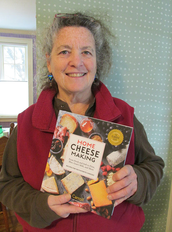 Lady holding a "Home Cheese Making" book