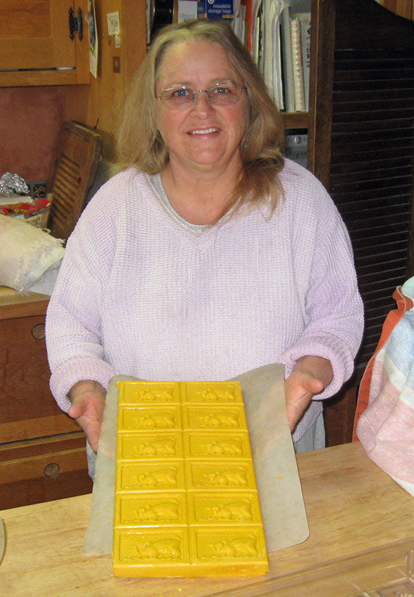 Woman holding out goat milk soap