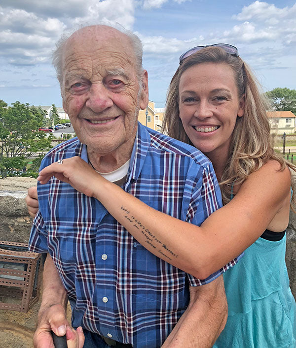 Grandpa with his granddaughter who has her arm around him