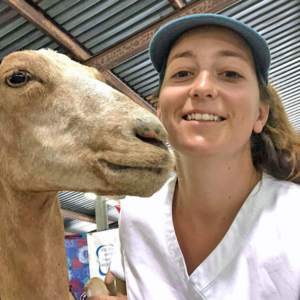 Selfie of woman and tan goat