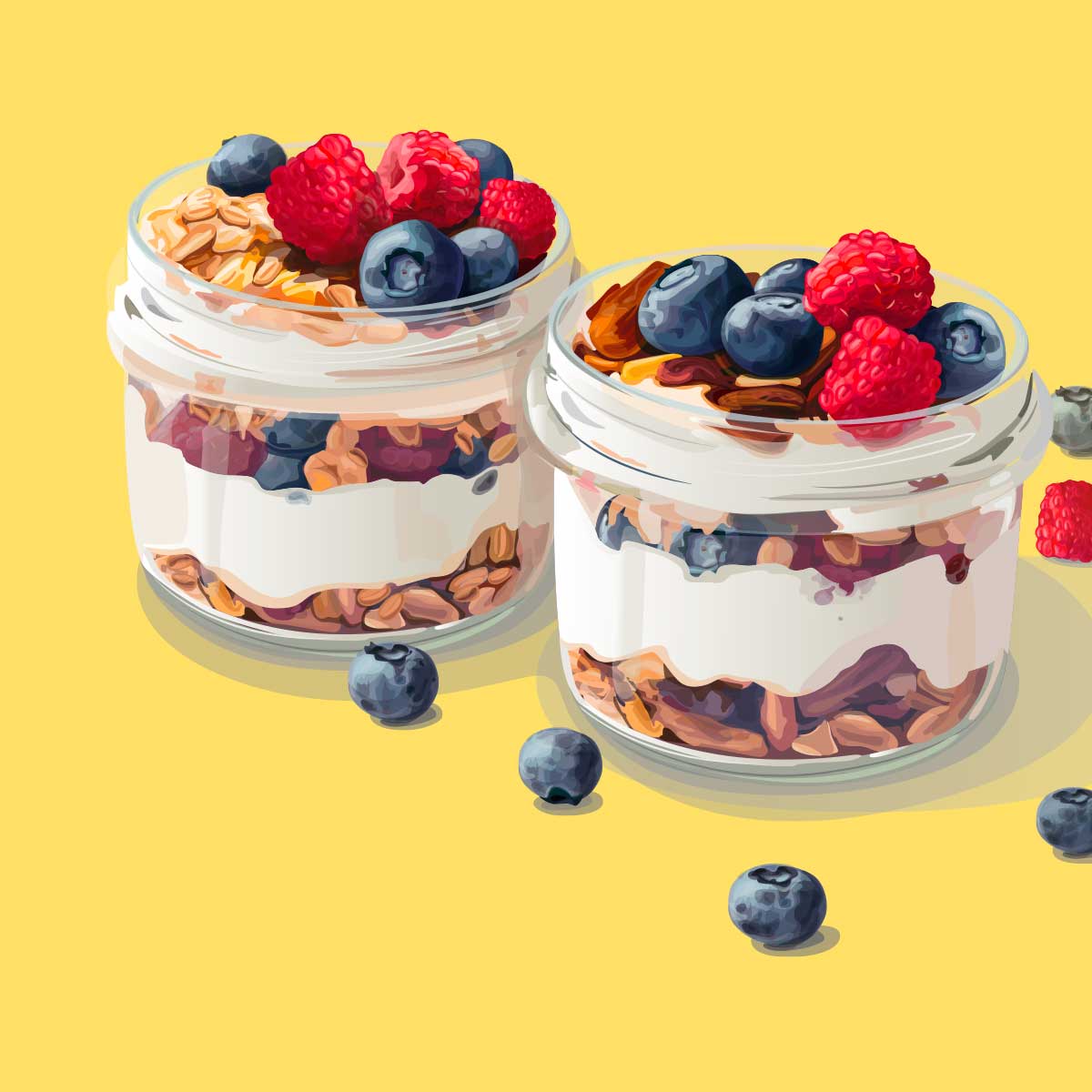 Two glass jars of homeade yogurt parfaits with layers of granola, blueberries and raspberries